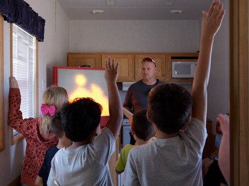 Brad Keibler, Goodfellow Fire Department fire inspector, engages with youth from the school-age facility during National Fire Week at Goodfellow Air Force Base, Texas, Oct. 11, 2023.