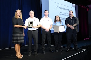 Members from the 97th Maintenance Group accept the Department of Defense Safety and Occupational Health Management System Achievement Award at the Volunteer Protection Programs Participants’ Association Safety+ Symposium in Orlando, Florida, Sept. 18, 2023. The award is presented to encourage a continuous positive safety culture and to recognize the hard work of the DoD installations and individuals committed to achieving safe workplaces. (Courtesy photo)