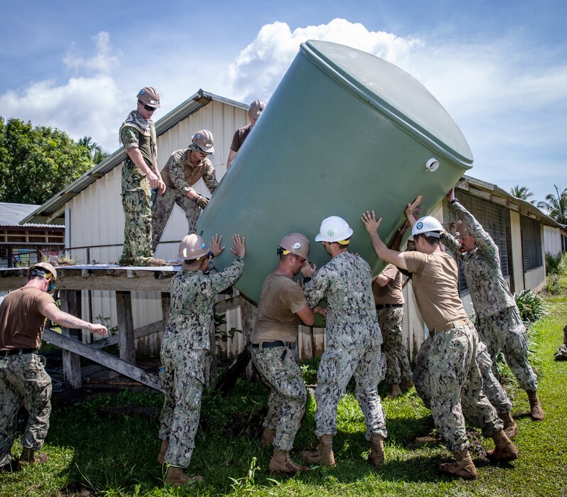 Seabees supporting Pacific Partnership 2023 remove a water container during a renovation project at Mongniol Primary School in Wewak, Papua New Guinea.