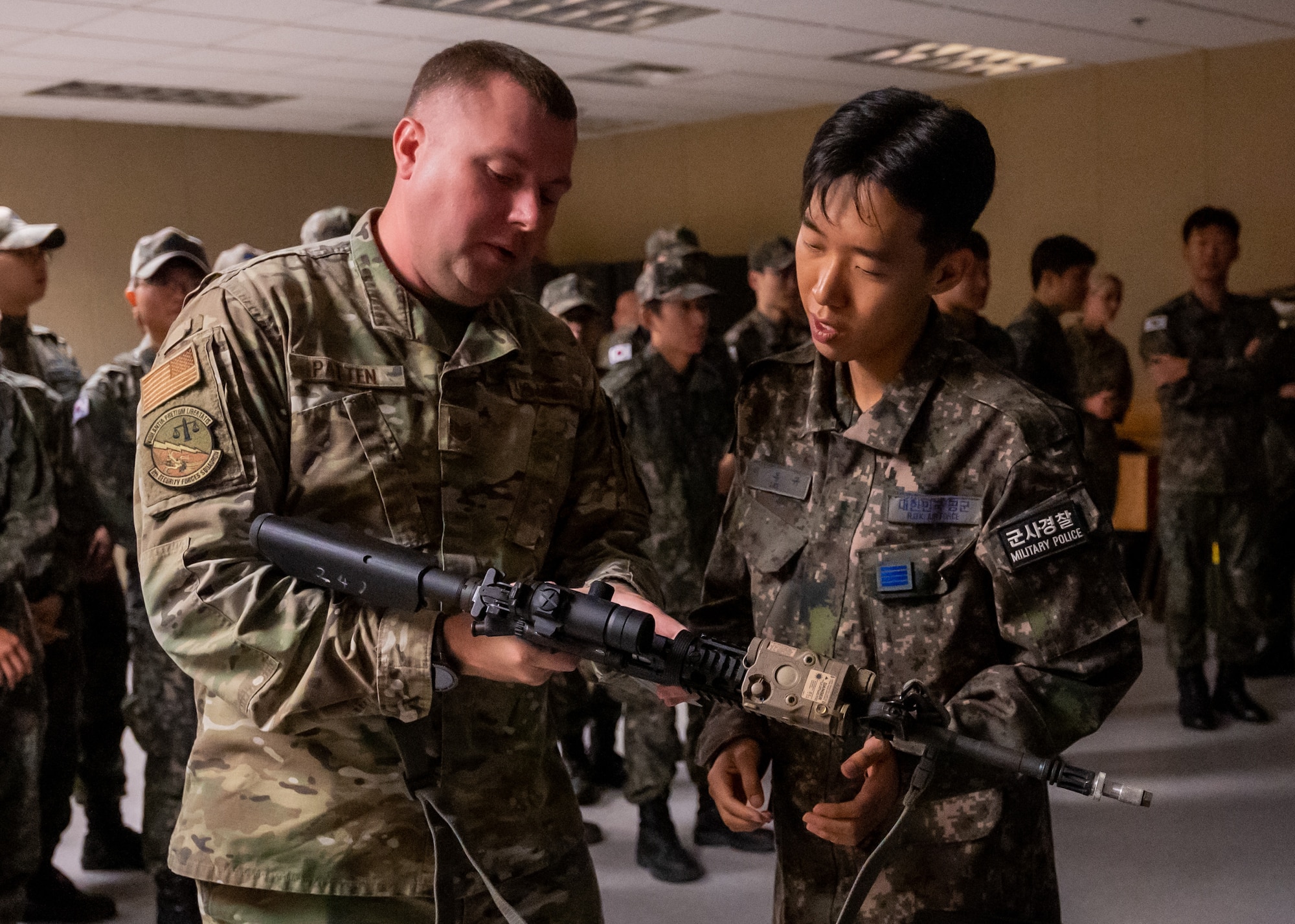 U.S. Air Force Tech. Sgt. Alex D. Patten demonstrates the M4 Carbine’s capabilities to a Republic of Korea Air Force 38th Fighter Group military police officer prior to attending virtual firearm training.
