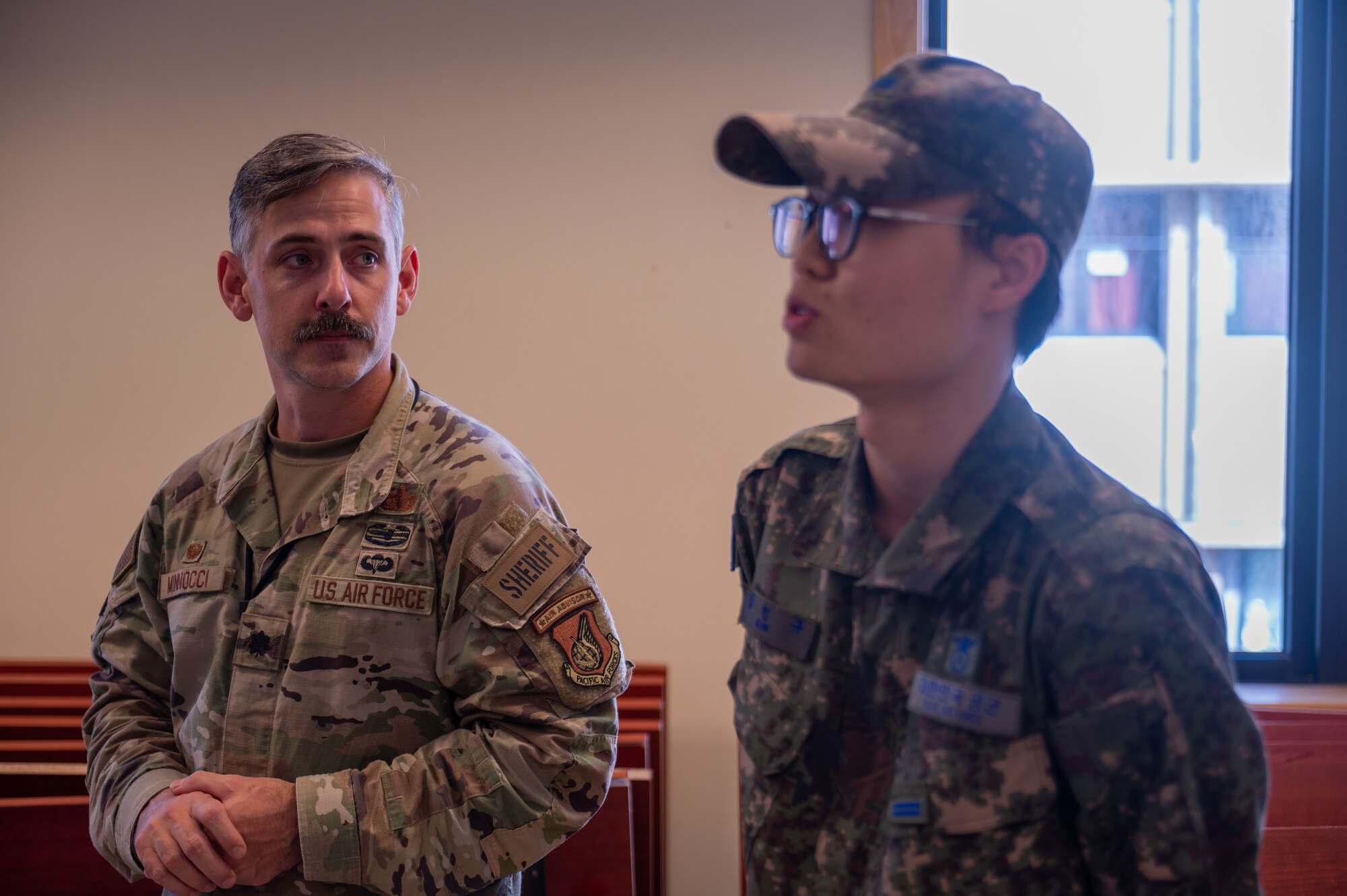 U.S. Air Force Lt. Col. Daniel , left, briefs alongside a translator from the Republic of Korea Air Force about the significance of the first-ever combined security patrols.