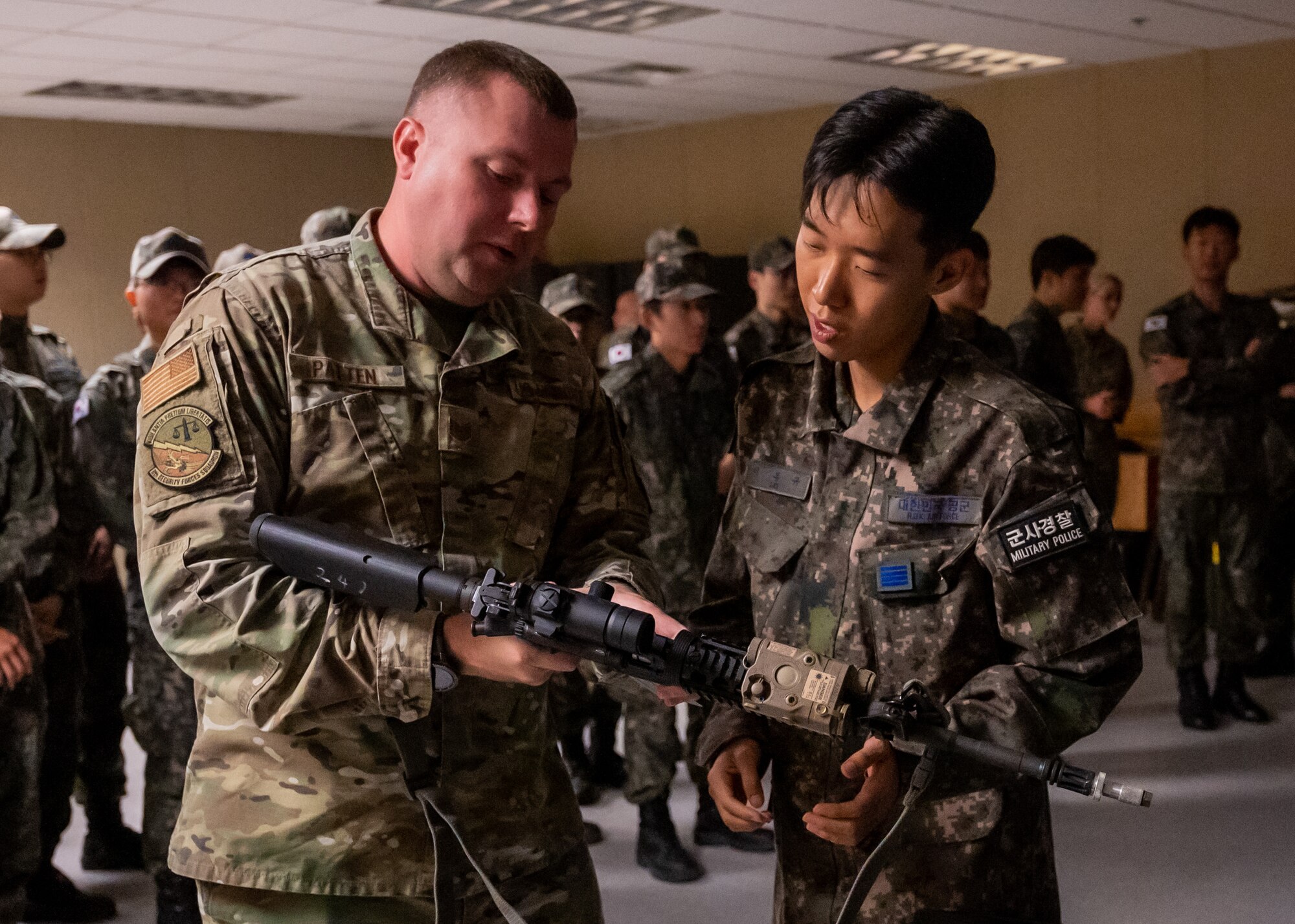 U.S. Air Force Tech. Sgt. Alex D. Patten demonstrates the M4 Carbine’s capabilities to a Republic of Korea Air Force 38th Fighter Group military police officer prior to attending virtual firearm training.