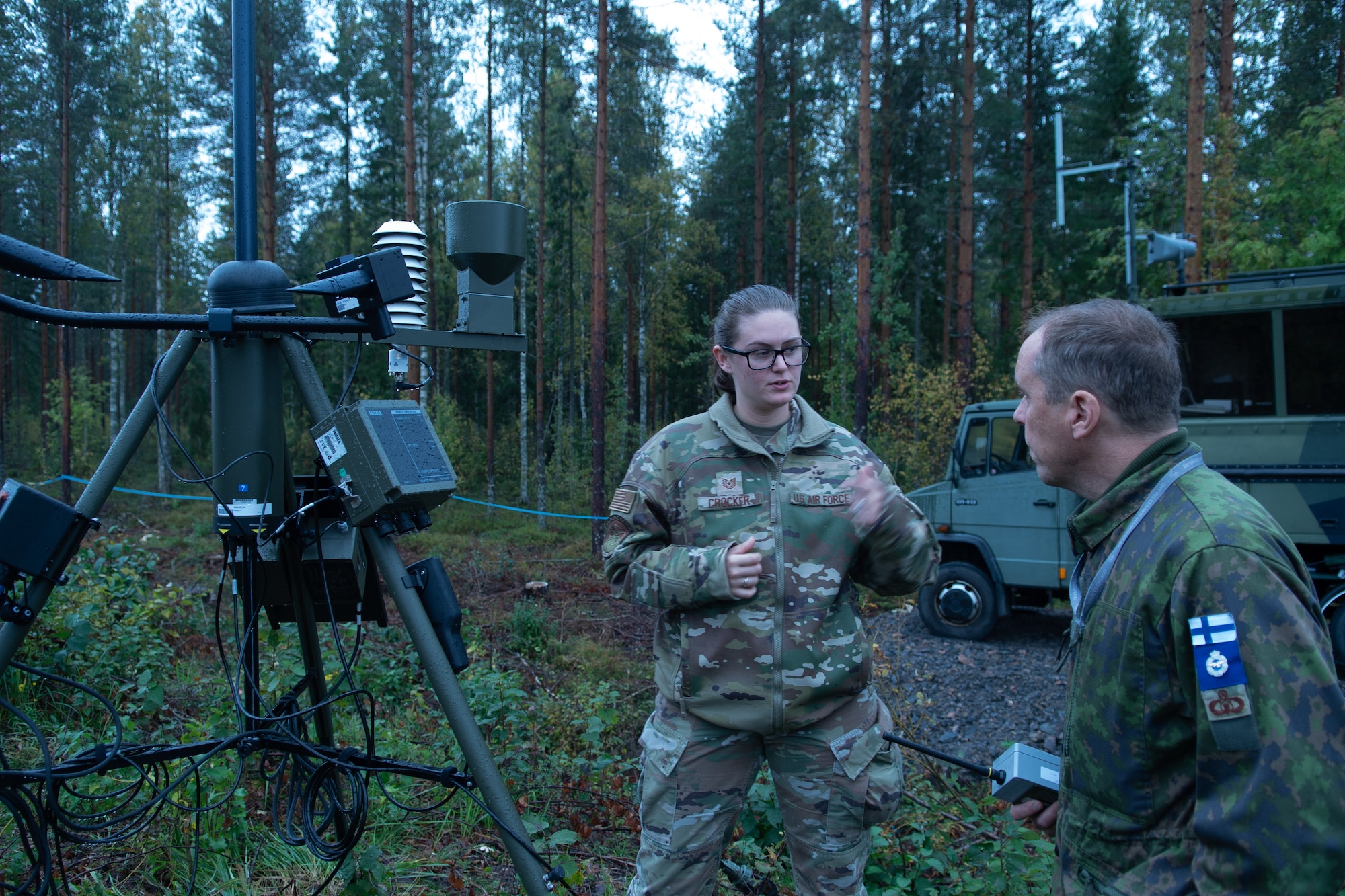 A photo of two people standing next to equipment.