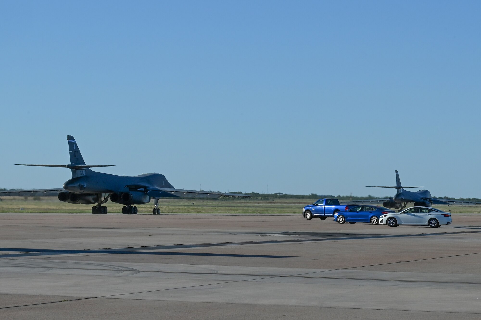 Two B-1B Lancers taxi on the flightline at Dyess Air Force Base, Texas, Oct. 11, 2023, to kick off a U.S. European Command Bomber Task Force deployment. The bombers will participate in joint and combined training, exercises, and operations, which help mitigate and reduce security risks associated with increased human activity in the Arctic. (U.S. Air Force photo by Senior Airman Sophia Robello)