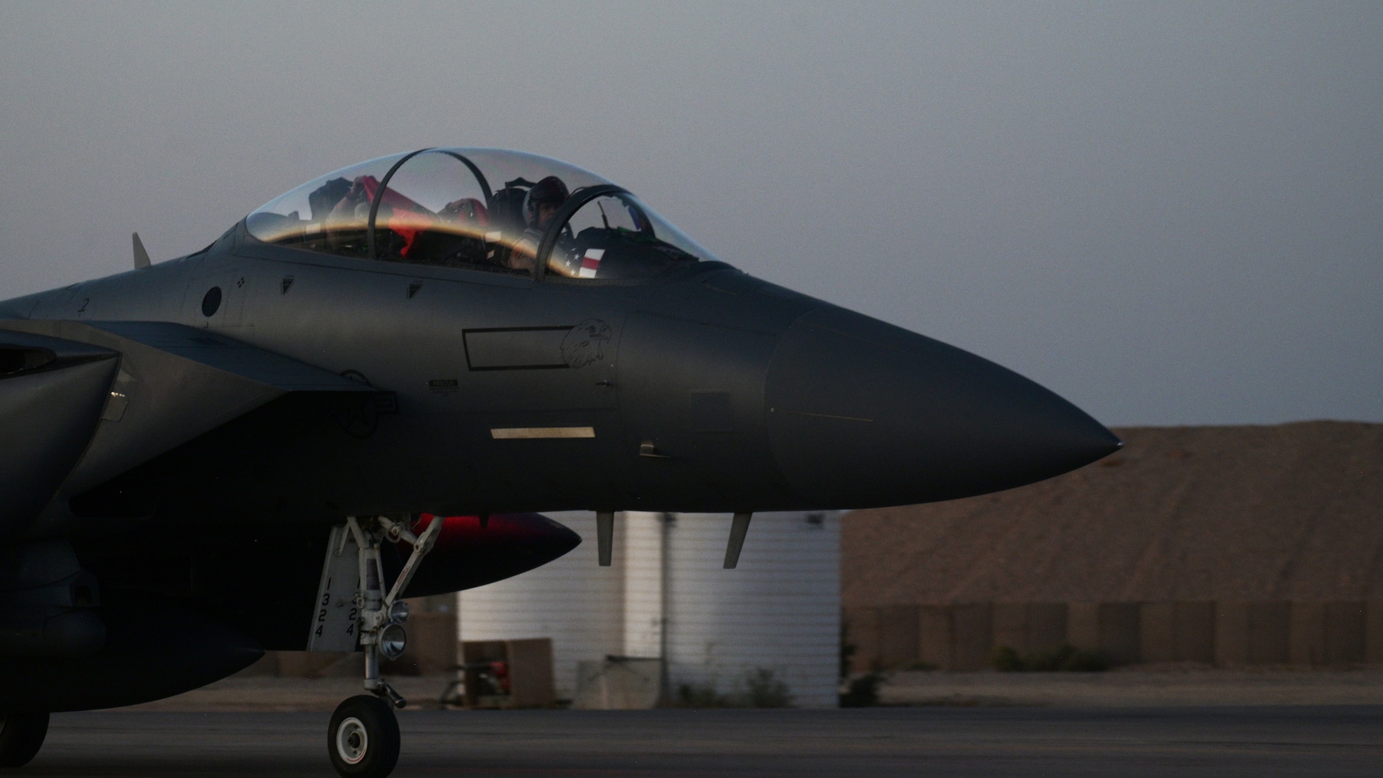 Aircrew aboard a U.S. Air Force F-15E Strike Eagle assigned to the 494th Expeditionary Fighter Squadron celebrate their arrival in the U.S. Central Command area of operations, Oct. 13, 2023. The Strike Eagle offers a wide-range of combat capabilities, which further enhance the U.S. and coalition’s ability to operate freely and effectively across the air domain throughout the Middle East. (U.S. Air Force photo by Airman 1st Class Josephine Pepin)