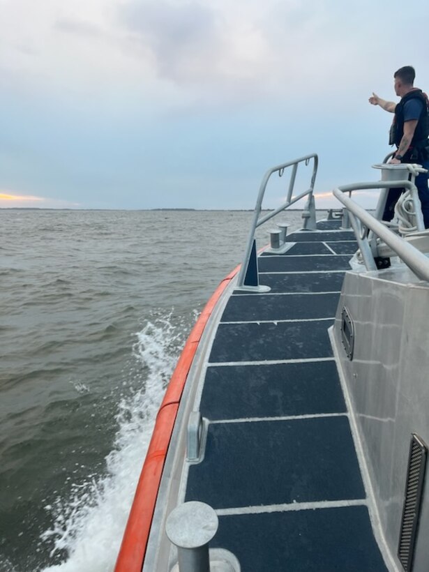 A Coast Guard Station Georgetown 45-foot Response Boat–Medium crew rescues two people from the water after their 44-foot sailing vessel sank near the jetties by the entrance to Winyah Bay in Georgetown, South Carolina, Oct. 13, 2023.