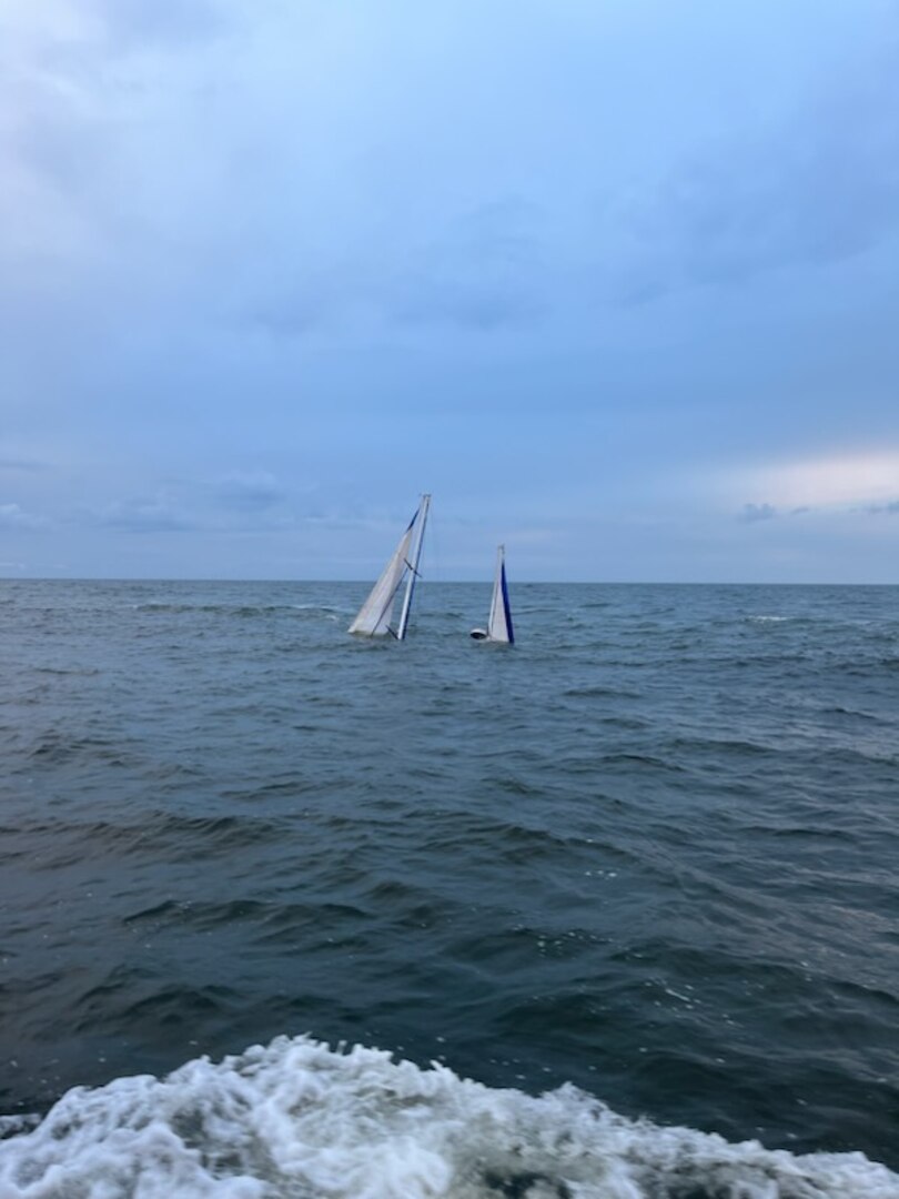 A Coast Guard Station Georgetown 45-foot Response Boat–Medium crew rescues two people from the water after their 44-foot sailing vessel sank near the jetties by the entrance to Winyah Bay in Georgetown, South Carolina, Oct. 13, 2023.