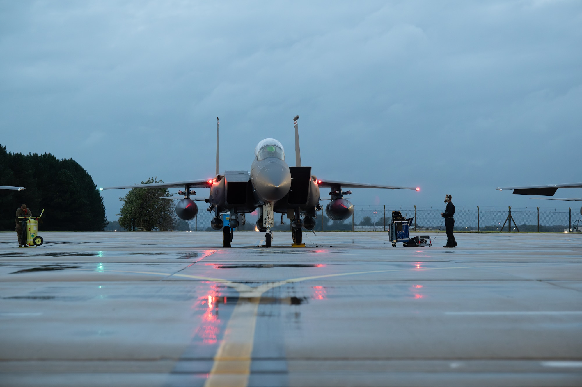 An F-15E Strike Eagle aircraft sits on a runway