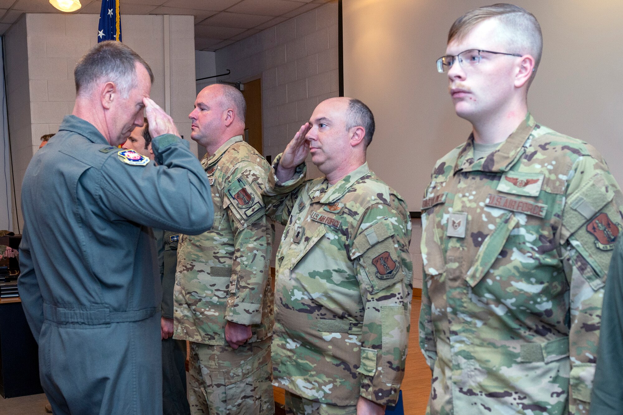 U.S. Air Force Lt. Col. Alex Hanna salutes Col. Christopher Sigler, left, 167th Operations Group commander, upon receiving an Air Medal with a C device denoting combat conditions, during a ceremony at Shepherd Field, Martinsburg, West Virginia, Oct. 14, 2023.