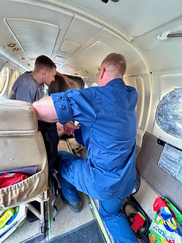 Capt. Nicholas Simmons, commander of U.S. Coast Guard Forces Micronesia/Sector Guam (CGFM/SG), receives a technical explanation from the radar operator inside the Sea Dragon aircraft on Sept. 20, 2023. Simmons led a delegation to the Republic of the Marshall Islands (RMI), one of the three former U.S. trust territories under the Compact of Free Association. The visit underscores CGFM/SG's strengthened role as the primary facilitator of the cooperative relationship between the U.S. Coast Guard and the RMI, reinforcing longstanding ties. (U.S. Coast Guard photo)