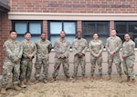 The 426 NWS team (left to right: TSgt Anthony Burney, Capt Rodolfo Morales, MSgt Andrienne Jeffers, SrA Jeremy Wilson, TSgt Wilson Szeto, and MSgt Mario Quintana) poses next to the corporation logo at Microsoft Corporation headquarters in Redmond, VA on Aug. 31, 2023. (Courtesy photo)
