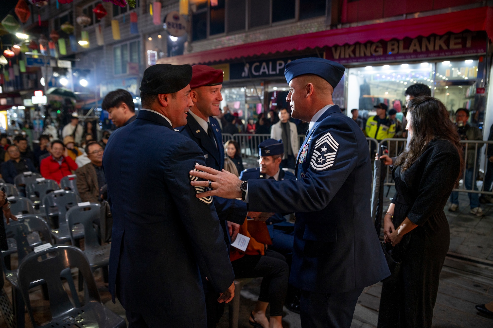 U.S. Air Force Chief Master Sgt. Joshua Trundle, right, 51st Fighter Wing command chief, greats Col. Patrick Lowe, middle, 607th Air Support Operations Group commander, and Chief Master Sgt. Dax Keehu, 607th ASOG command chief, during the 20th ROK U.S. Friendship Festival, in front of Osan Air Base, Republic of Korea, Oct. 14, 2023.