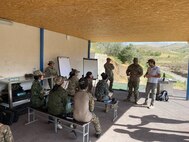 Three Virginia National Guard Soldiers discuss marksmanship skills with female members of the Tajik National Police Sept. 5-9, 2023, in Dushanbe, Tajikistan. The exchange supported the Department of Defense National Guard Bureau State Partnership Program.