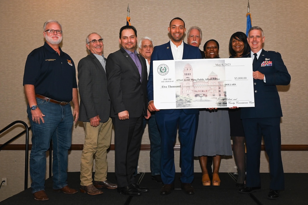 Tommy Calvert Jr., Bexar County Precinct 4 commissioner, and the Bexar County Commissioners Court donates a $5,000 check to the 433rd Airlift Wing Angel Wings Over the Alamo program during the 433rd AW 2023 Honorary Commanders’ Induction Ceremony in San Antonio, Texas, May 6, 2023.
