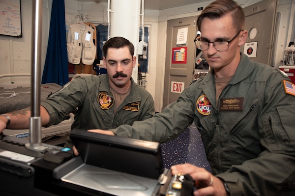 From left, Hospital Corpsman 2nd Class Bradley Christian, a search and rescue medical technician assigned to Navy Medicine Readiness and Training (NMRTC) Patuxent River, and Lt. Kyle Rowland, a critical care nurse assigned to NMRTC Camp Lejeune, test an integrated intensive care mobile unit during inventory in the medical department aboard Nimitz-class aircraft carrier USS Dwight D. Eisenhower (CVN 69).