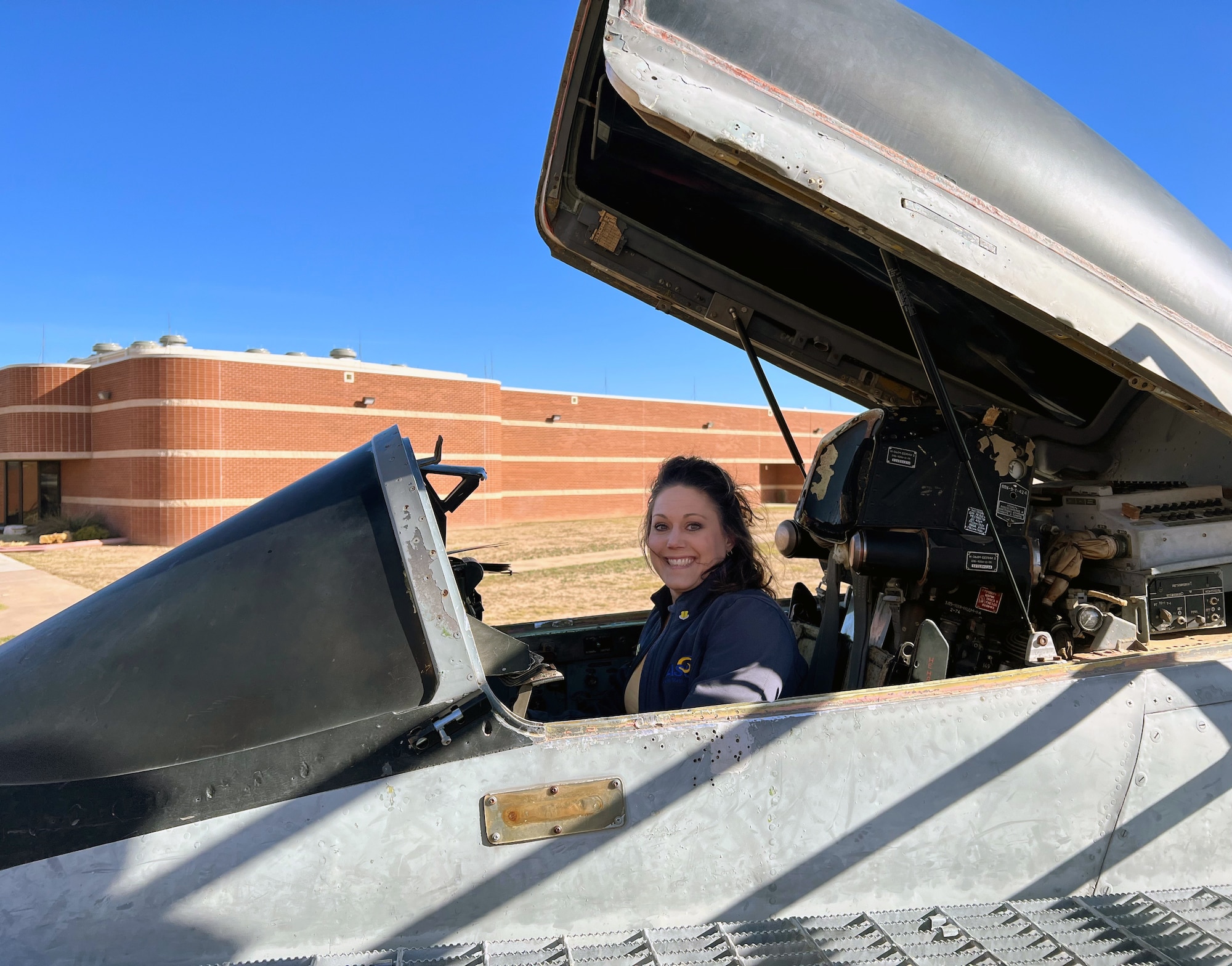 17th Training Wing Honorary Commander, Dr. Brook Dickison, sits in the cockpit of the MiG-29 Fulcrum training aid during a 17th TRW immersion event, at Goodfellow Air Force Base, Texas, Nov. 30, 2022.  The Honorary Commander Program is designed to give emerging leaders in the local community a chance to learn more about the base, the Air Force, the Department of Defense and the training mission at Goodfellow AFB.  (Courtesy photo)