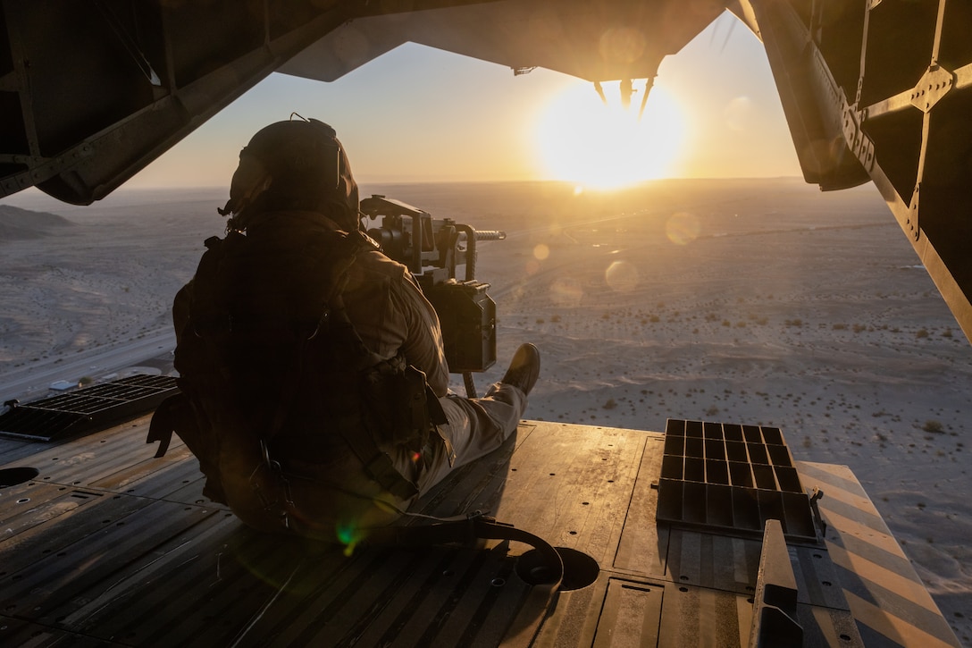 U.S. Marine Corps Sgt. Antonio Trujillo, a CH-53K King Stallion crew chief with Marine Heavy Helicopter Squadron (HMH) 461, sits on the ramp of a CH-53K during a terrain-familiarization flight as part of Weapons and Tactics Instructor (WTI) course 1-24 near Yuma, Arizona, Oct. 10, 2023. The WTI course is an advanced, graduate-level, seven-week course hosted by Marine Aviation Weapons and Tactics Squadron (MAWTS) 1, which provides standardized advanced tactical training and certification of unit instructor qualifications, to support Marine aviation training and readiness and to assist in developing and employing aviation weapons and tactics. HMH-461 is a subordinate unit of 2nd Marine Aircraft Wing, the aviation combat element of II Marine Expeditionary Force. (U.S. Marine Corps photo by Cpl. Rowdy Vanskike)