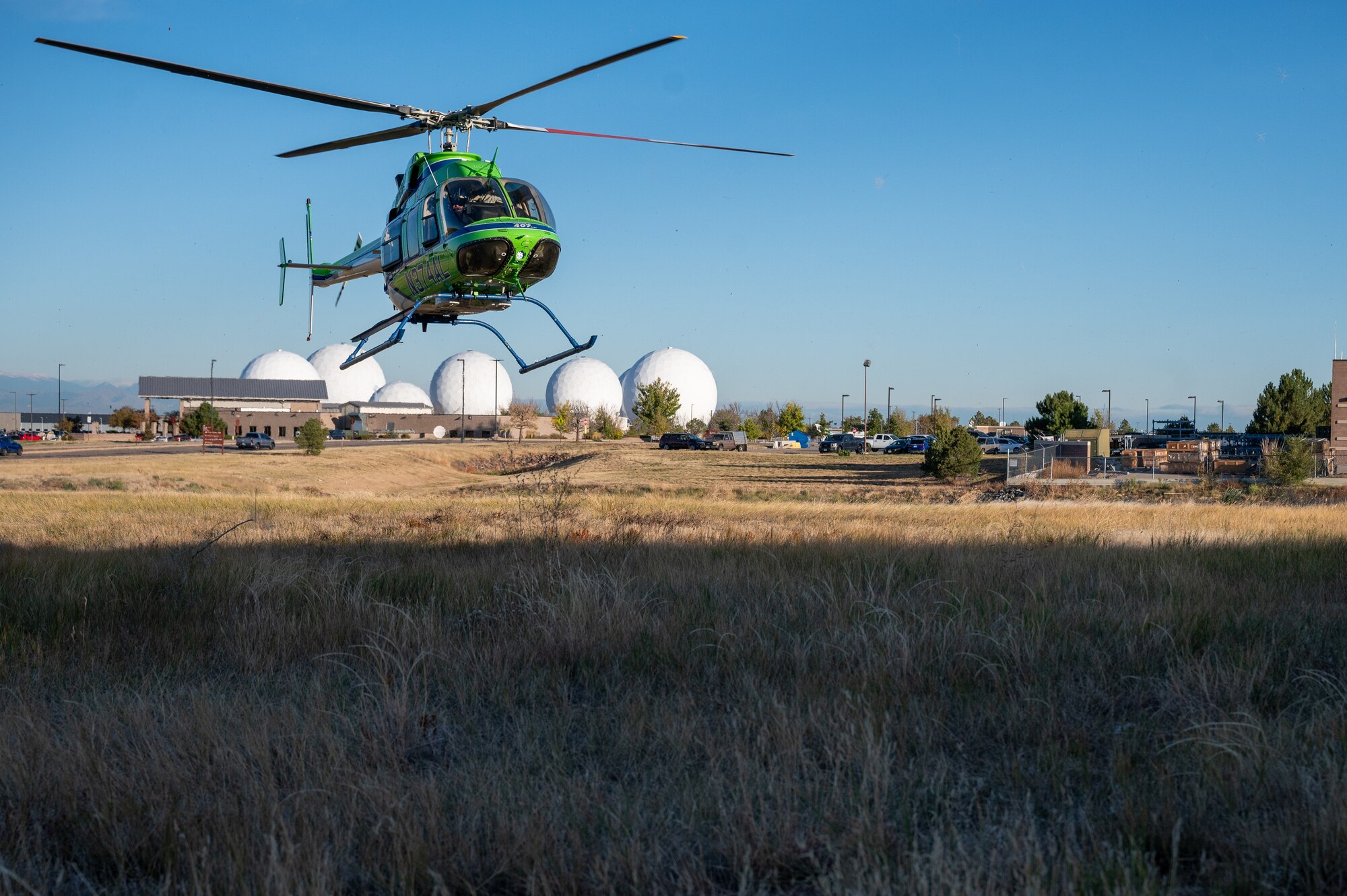 a helicopter prepares to land in a field.