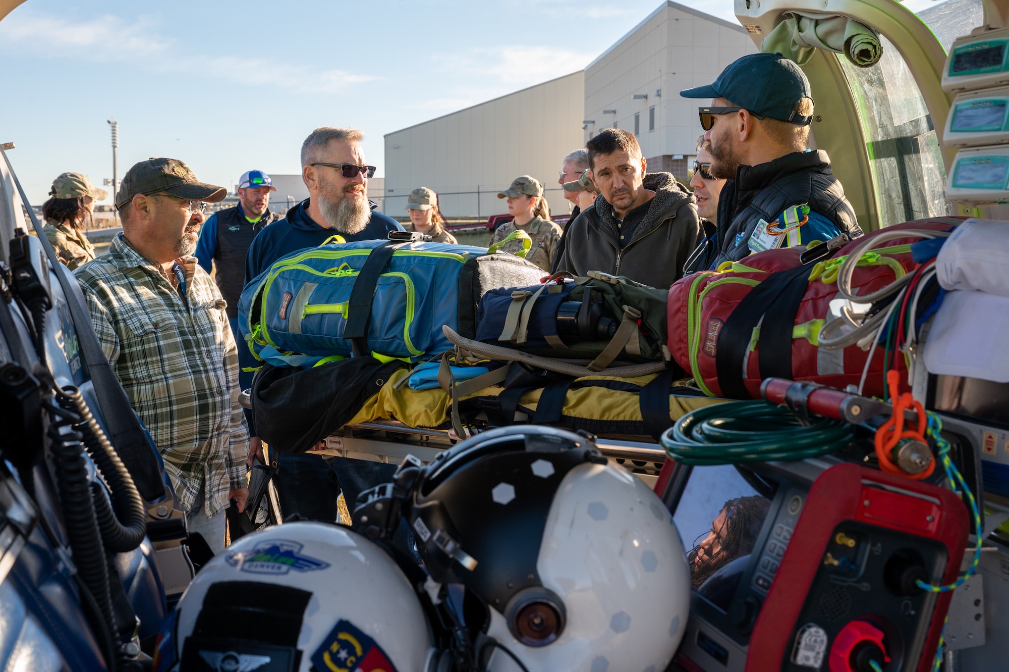 people gather around for a presentation of a rescue helicopter