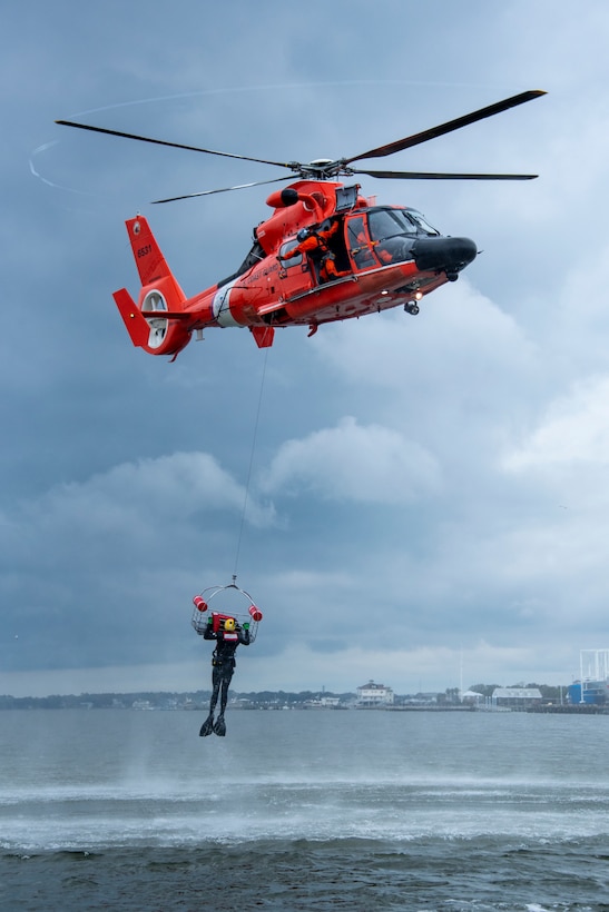 A Coast Guard Air Station Savannah MH-65 Dolphin helicopter crew conducts a search and rescue demonstration Feb. 19, 2020, in Charleston, South Carolina. The demonstration was performed for members of the media attending the State of the Coast Guard Address in Charleston. (U.S. Coast Guard photo by Petty Officer 2nd Class Ryan Dickinson)