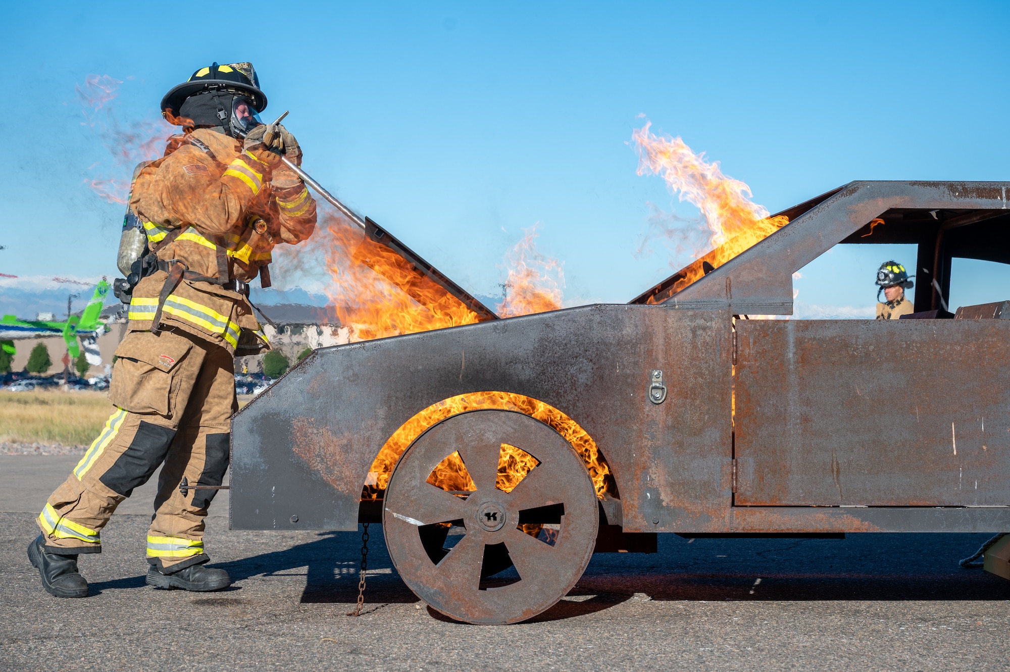 fireman opens burning car hood
