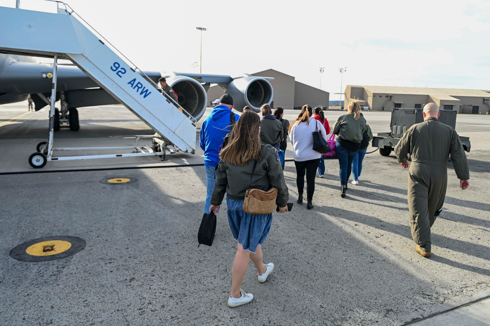 Spouses walk to a KC-135