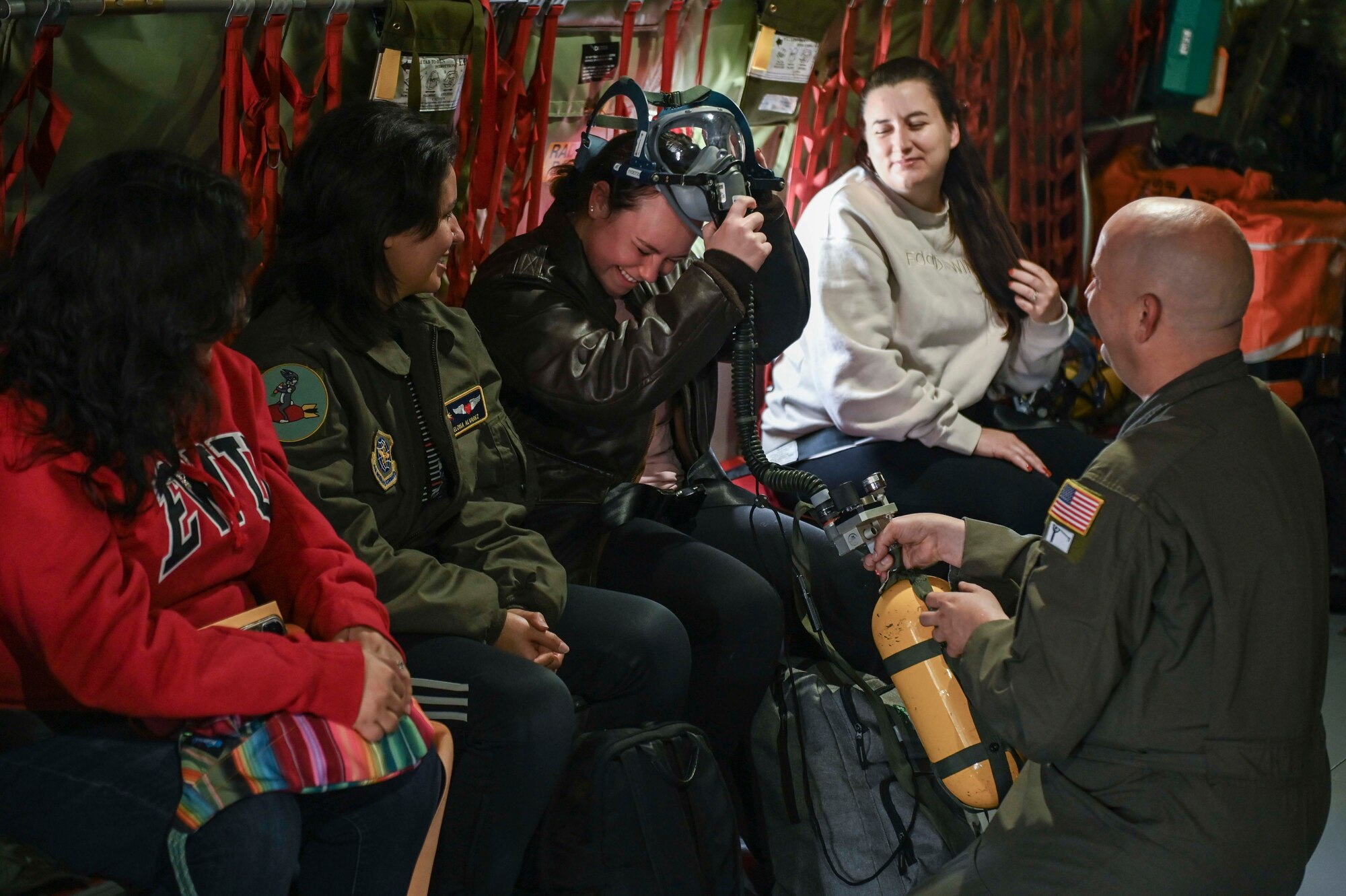 A spouse try's on an oxygen mask