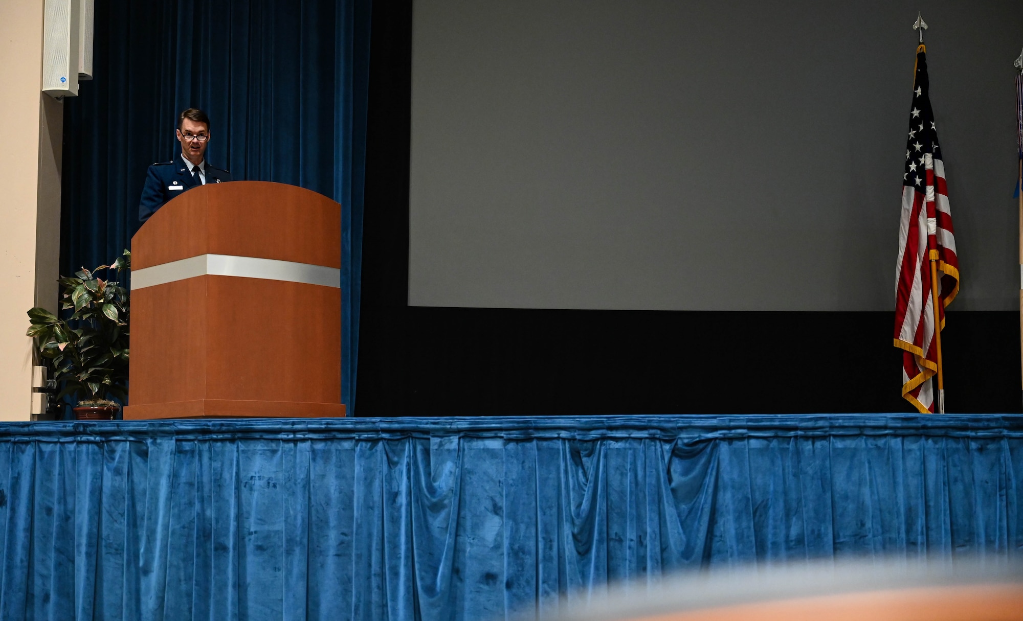 a man speaks at a lectern