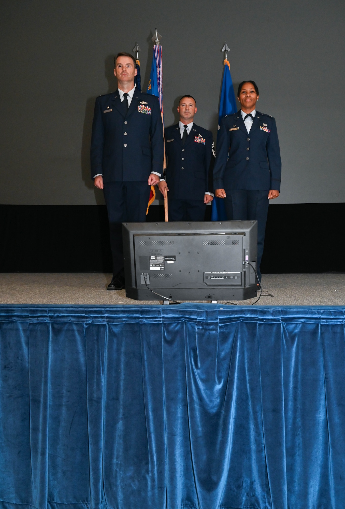 three people stand at attention
