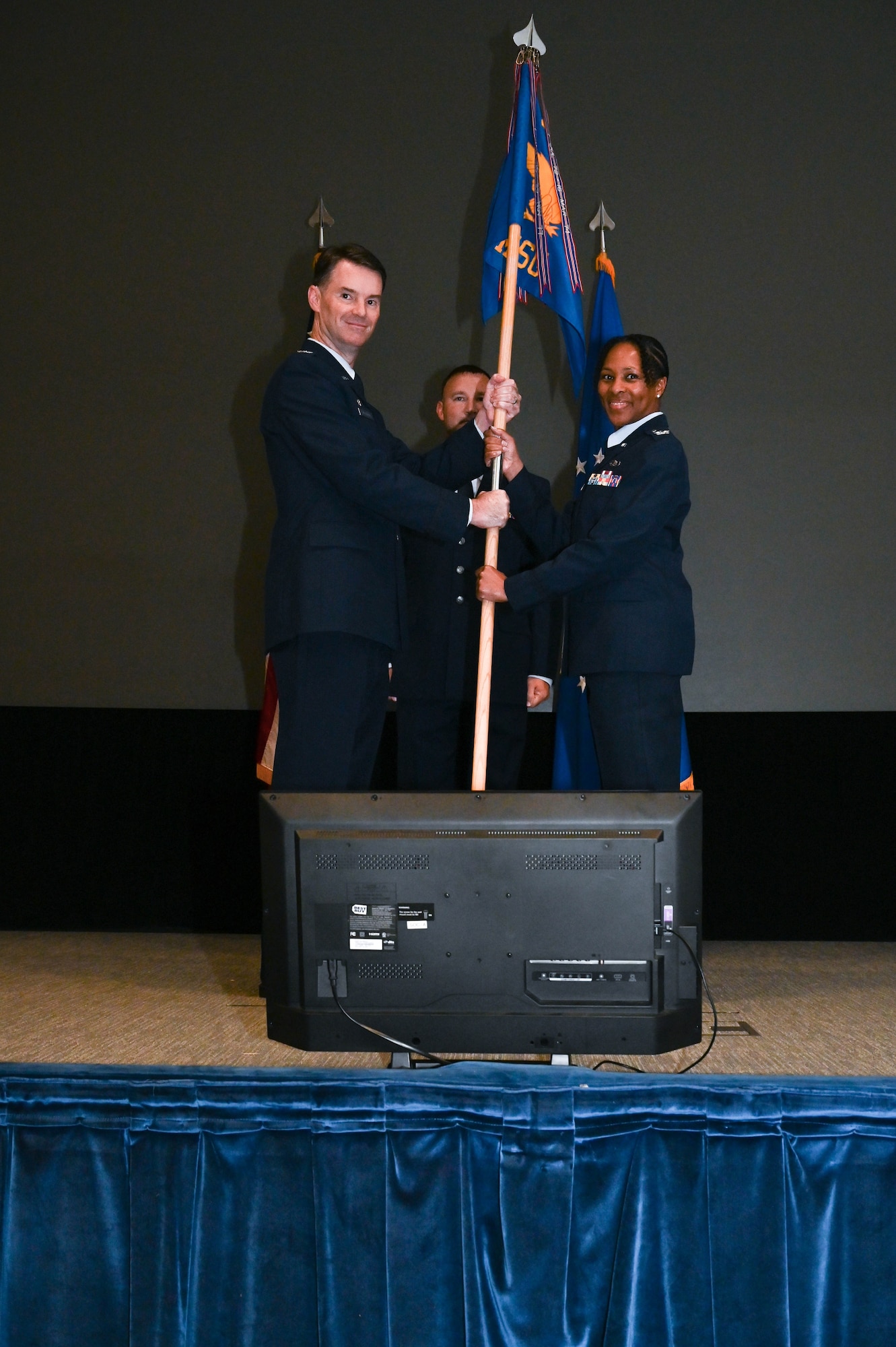 a person hands another person a flag