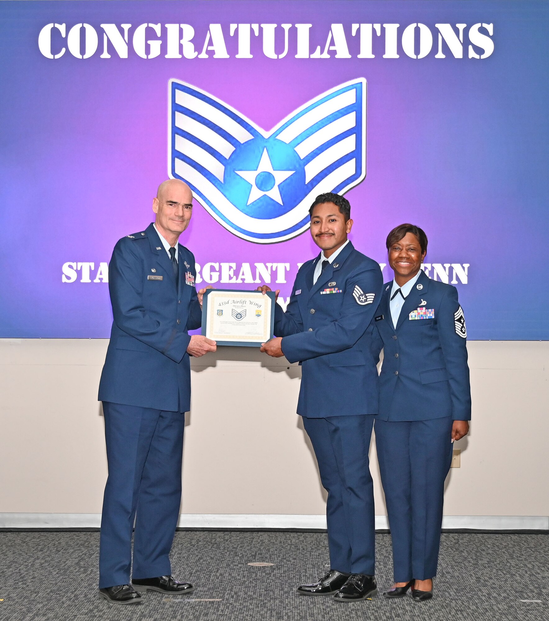 Staff Sgt. Larry Menn, 433rd Aircraft Maintenance Squadron maintainer, accepts a certificate of induction from Col. William Gutermuth, 433rd Airlift Wing commander, during an NCO Induction Ceremony October 15, 2023, at Joint Base San Antonio-Lackland, Texas. (U.S. Air Force photo by Master Sgt. Samantha Mathison)