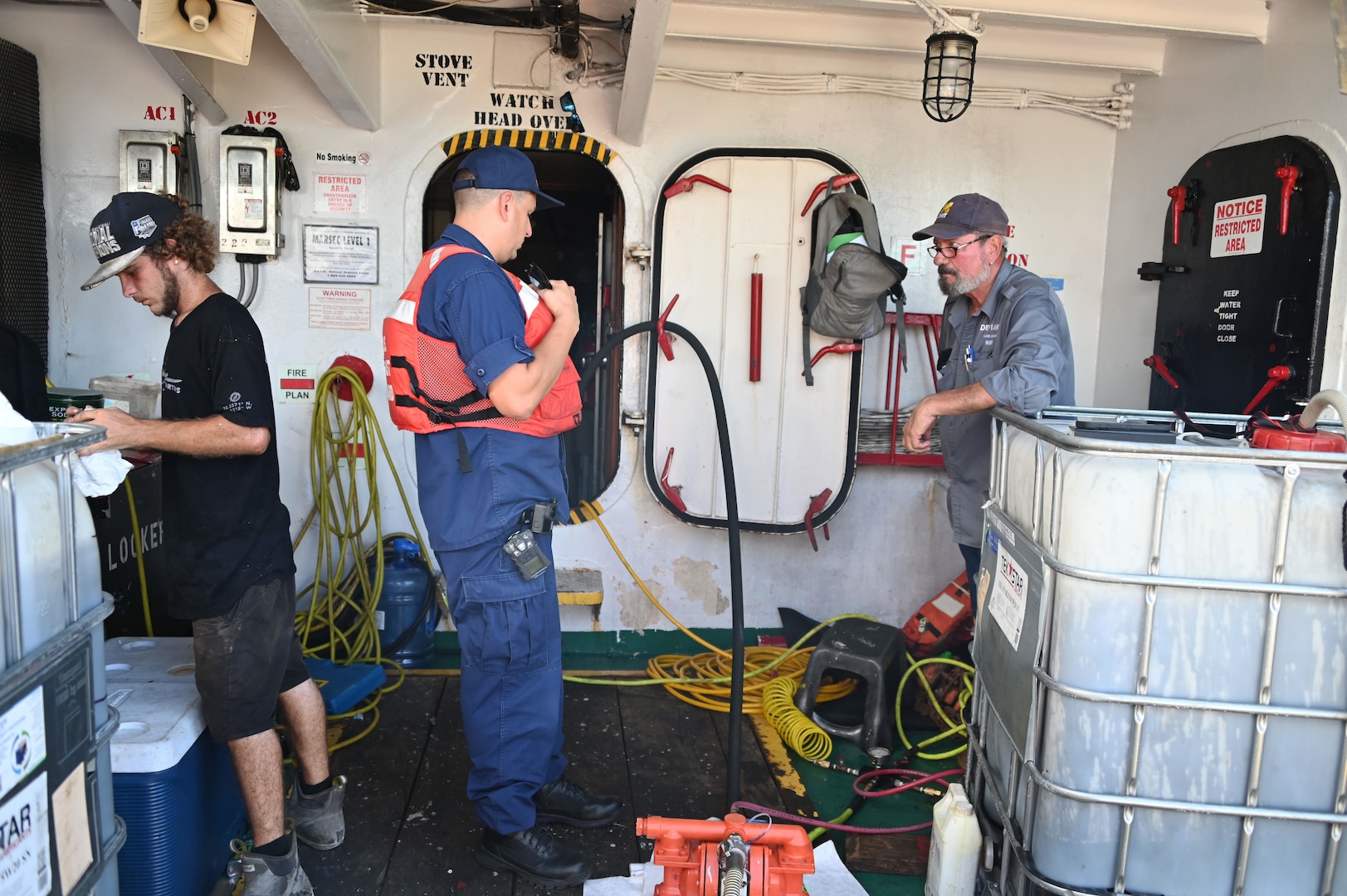 Coast Guard Incident Commander Lt. Cmdr. Christopher O'Conner is briefed by Robert Weihe, a Donjon-Smitt employee on decanting operations on the Bonnie G off Cyril E. King Airport, St. Thomas, Oct. 14, 2023. The Bonnie G, a 195-foot Vanuatu-flagged “ro-ro” cargo vessel that grounded on Oct. 4 during Tropical Storm Philippe. (Coast Guard photo by Petty Officer 1st Class Nicole J. Groll)