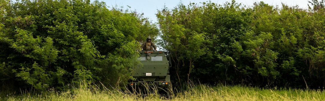 A U.S. Marine Corps High Mobility Artillery Rocket System with the 31st Marine Expeditionary Unit, III Marine Expeditionary Force, exits a hide before a simulated fire mission while training at Ie Shima Training Facility, Okinawa, Japan, Oct. 21, 2022. This training is part of Task Force 76/3’s Noble Fusion 22.2 campaign of learning and experimentation designed to improve naval integration within the newly created organization comprising of the U.S. Navy’s Task Force 76 and III MEF’s 3d Marine Expeditionary Brigade. (U.S. Marine Corps photo by Staff Sgt. Andrew Ochoa)