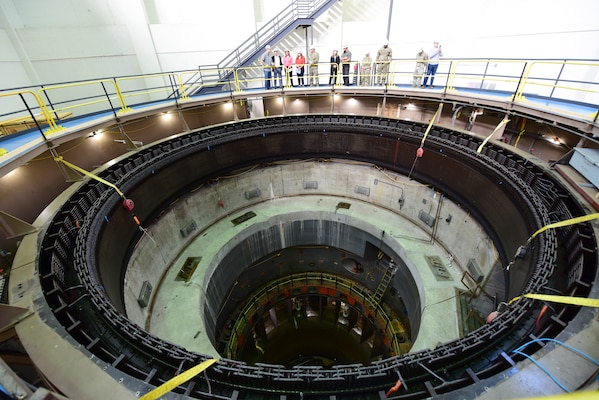 Secretary of the Army for Civil Works Michael L. Connors, Lt. Col. Robert W. Green, U.S. Army Corps of Engineers Nashville District commander, and employees look into a hydropower unit being rehabilitated during a tour of the Barkley Dam Powerplant in Kuttawa, Kentucky, Oct. 13, 2023. (USACE Photo by Lee Roberts)