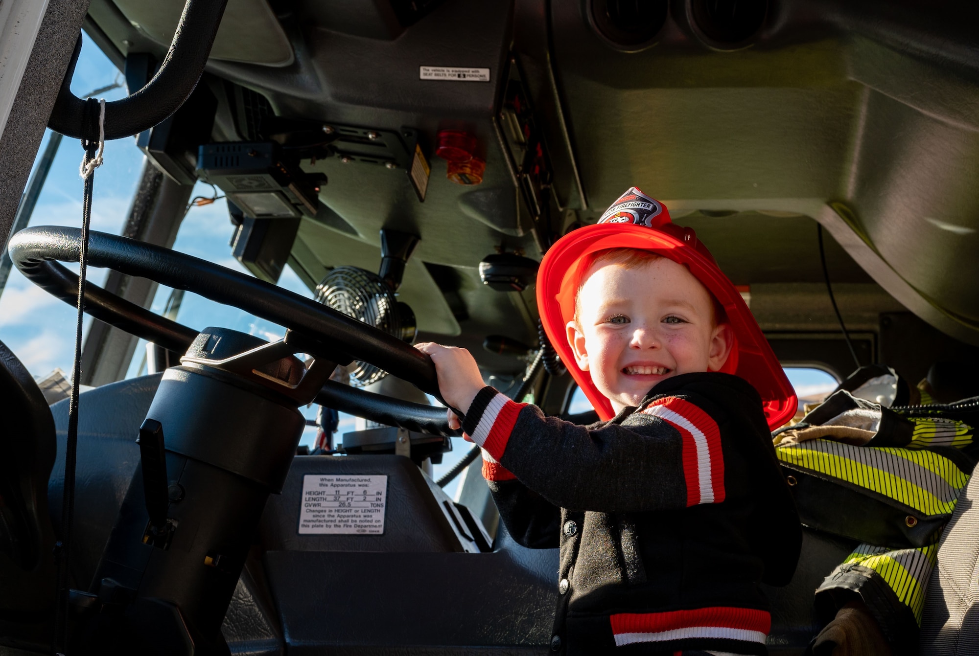 A future Dover Air Force Base Fireman smiles for a photo before the 2023 Fire Prevention Week Parade on Dover Air Force Base, Delaware, Oct. 13, 2023. Fire Prevention Week is a nation-wide observation that teaches people how to stay safe in case of a fire. (U.S. Air Force photo by Airman 1st Class Amanda Jett)