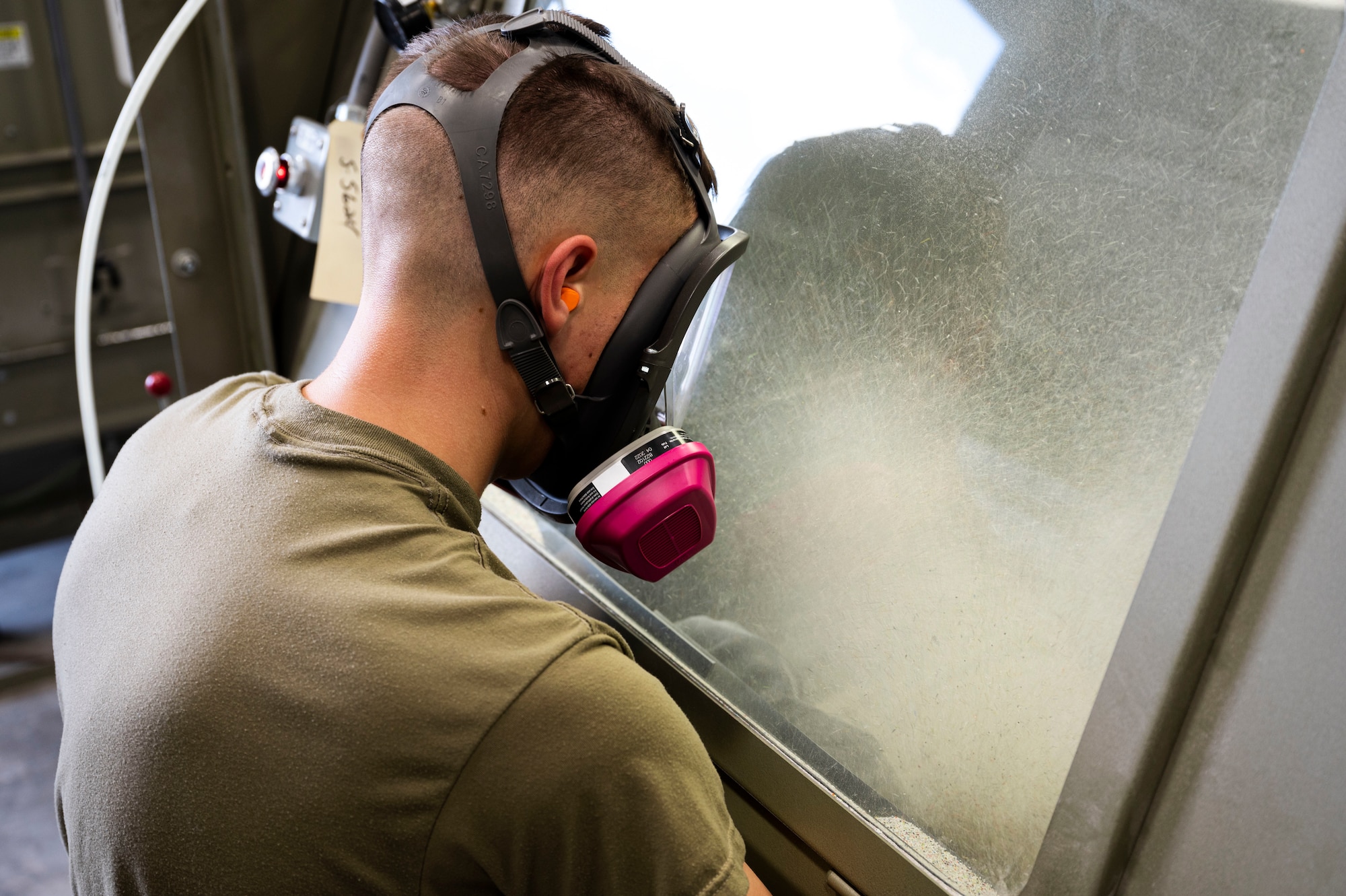 U.S. Air Force Airman Caleb Pridemore, 49th Equipment Maintenance Squadron aircraft structural maintenance apprentice, sandblasts a piece of aircraft metal at Holloman Air Force Base, New Mexico, Oct. 2, 2023. The corrosion shop is primarily responsible for ensuring that the structural parts of Holloman’s F-16 Vipers are properly painted, sanded and free of any corrosive damage. (U.S. Air Force photo by Airman 1st Class Isaiah Pedrazzini)