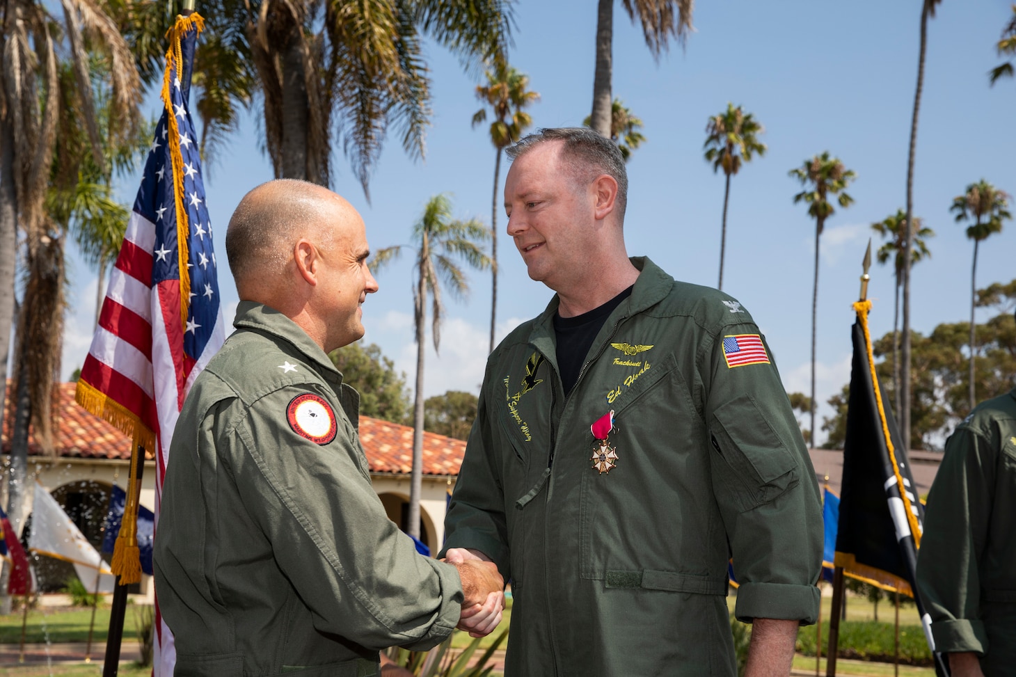 Commander, Naval Air Force Reserve Rear Adm. Brad Dunham (left) shakes the hand of outgoing Commodore, Maritime Support Wing (MSW) Capt. Edward Hoak (right) during the MSW Change of Command Ceremony.