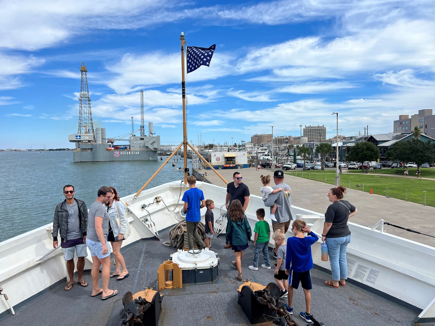 Visitors tour the forward deck of Coast Guard Cutter Reliance, a 210-foot medium endurance cutter homeported in Pensacola, Florida, at Pier 21 in Galveston, Texas, Oct. 8, 2023. The Reliance was built in Houston and commissioned in Galveston in 1964.