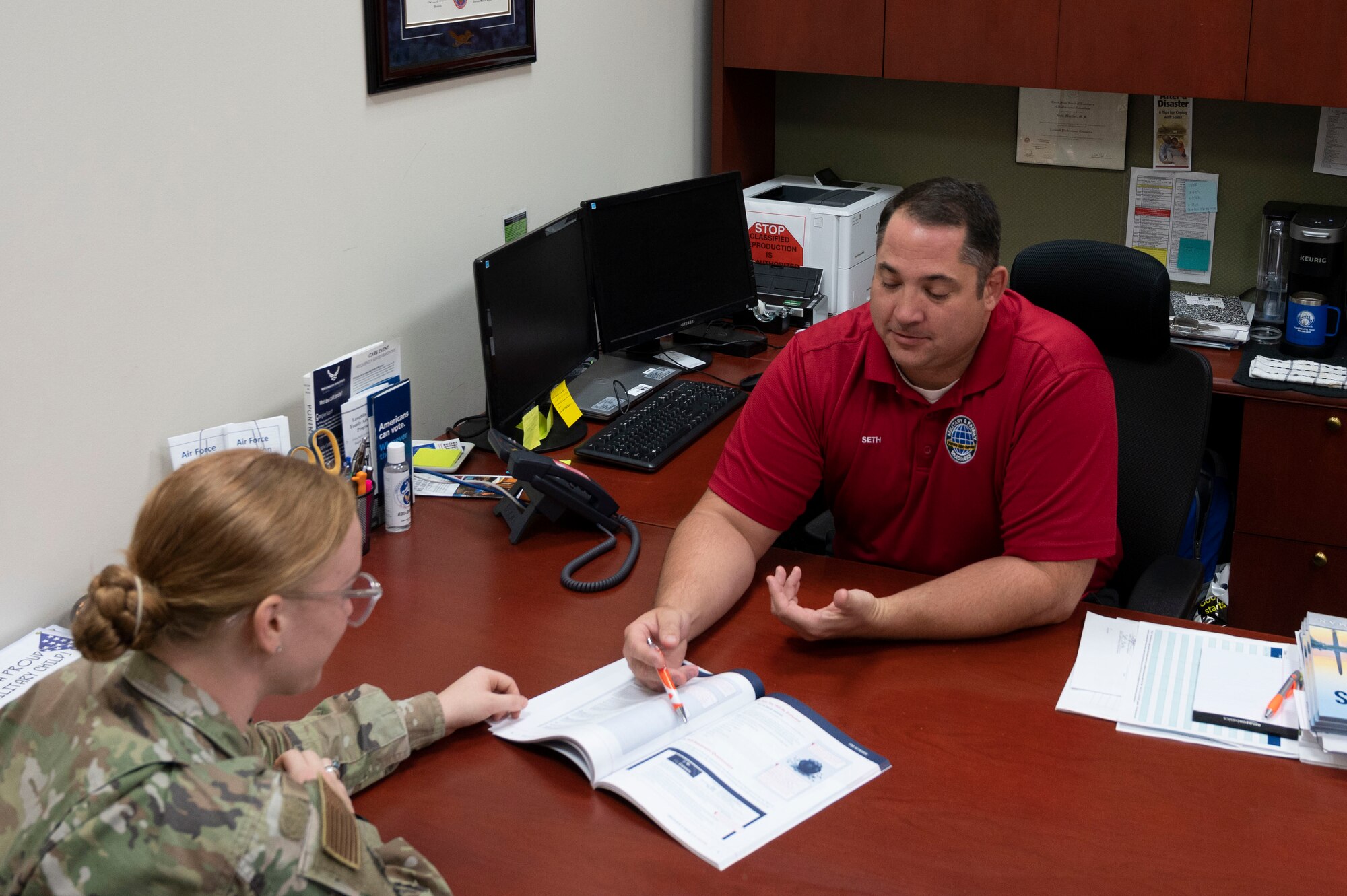 Seth Martini, 47th Force Support Squadron financial advisor, speaks with U.S. Air Force Airman 1st Class Kailee Reynolds, 47th Flying Training Wing public affairs specialist, at the Military and Family Readiness Center at Laughlin Air Force Base, Texas, Oct. 13, 2023. Martini offers Airmen a wide variety of financial readiness training, including investing, retirement, and deployment. (U.S. Air Force photo by Airman 1st Class Kailee Reynolds)