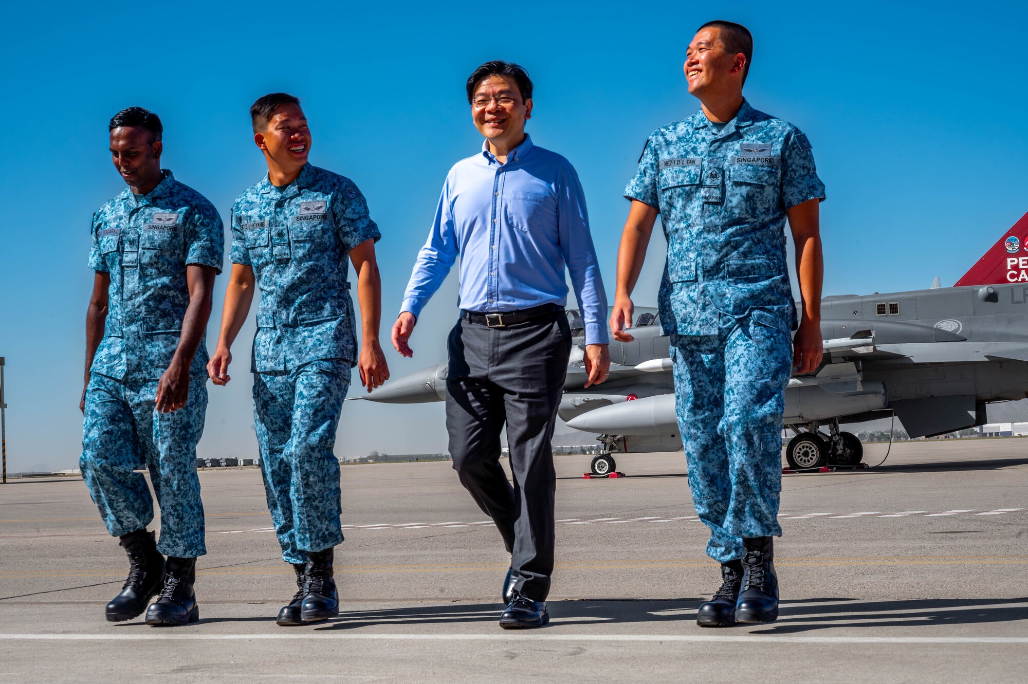 Lawrence Wong (center right), Singapore Deputy Prime Minister and Minister of Finance, walks on the flight line with members of the Republic of Singapore Air force. Oct. 6, 2023, at Luke Air Force Base, Arizona.
