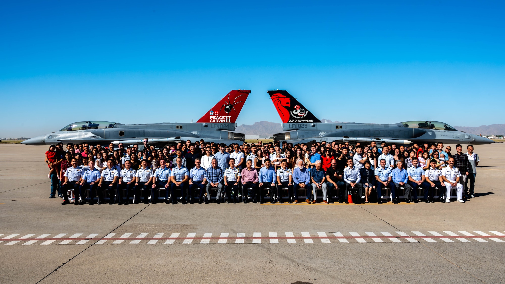 Members of the 425th Fighter Squadron, 425th Aircraft Maintenance Unit, and 56th Fighter Wing, pose for a photo in front of two republic of Singapore F-16 Fighting Falcons Oct. 6, 2023, at Luke Air Force Base, Arizona.