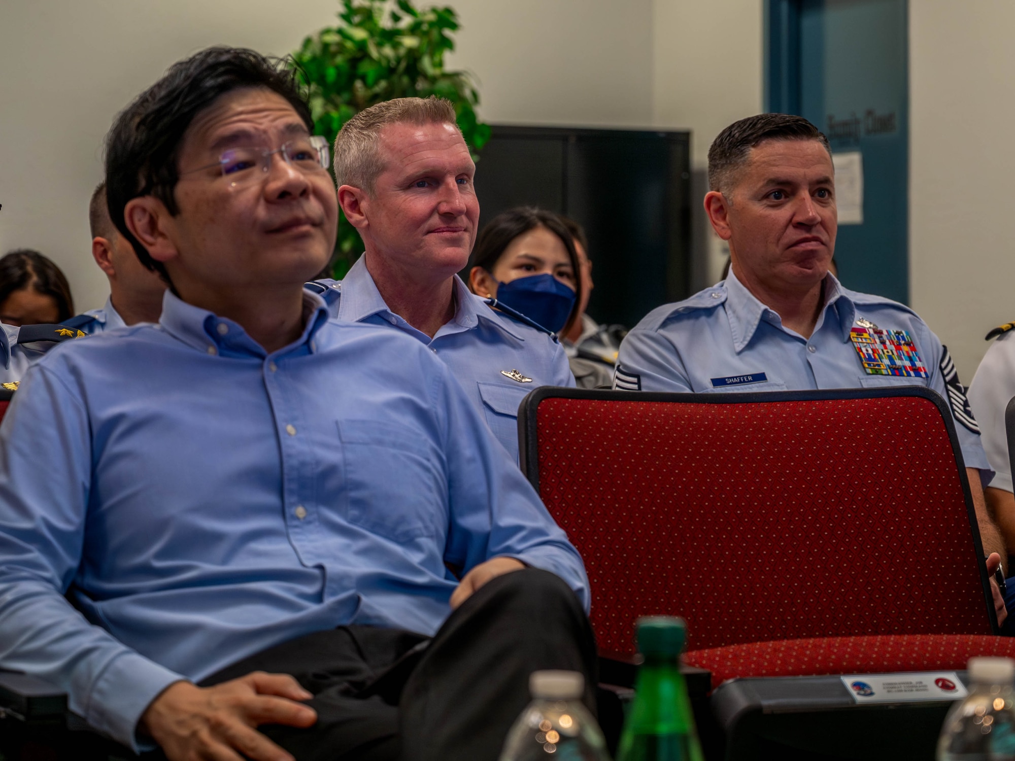 Lawrence Wong (left), Singapore Deputy Prime Minister and Minister of Finance, and U.S. Air Force Brig. Gen. Jason Rueschhoff (center), 56th Fighter Wing commander, and Chief Master Sgt. Jason Schaffer, 56th FW command chief, attend a briefing Oct. 6, 2023, at Luke Air Force Base, Arizona.