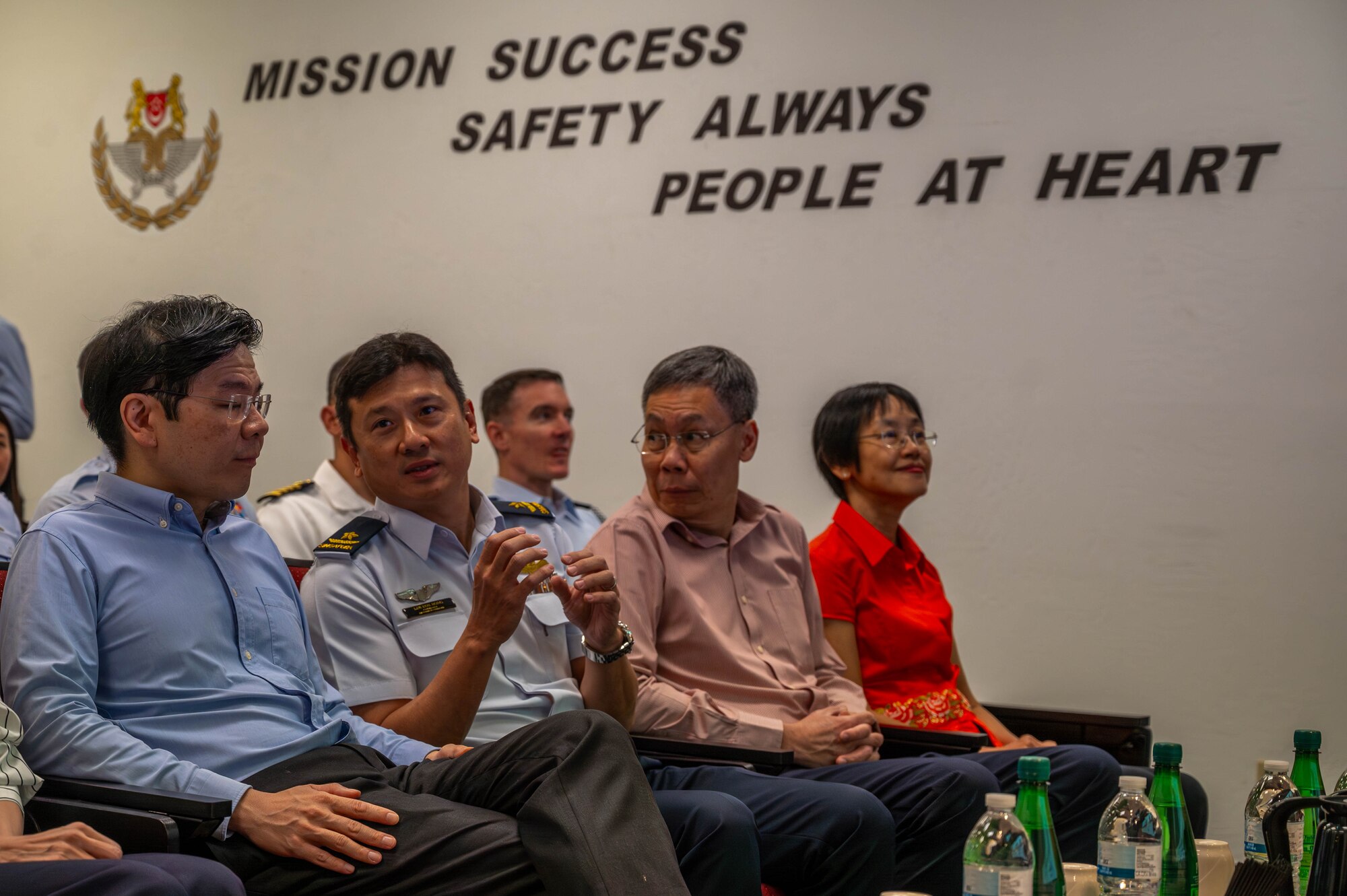 Lawrence Wong (left), Singapore Deputy Prime Minister and Minister of Finance, and Republic of Singapore Air Force Brig. Gen. Lim Kok Hong (center left), RSAF Air Combat Command commander, converse during a briefing Oct. 6, 2023, at Luke Air Force Base, Arizona.