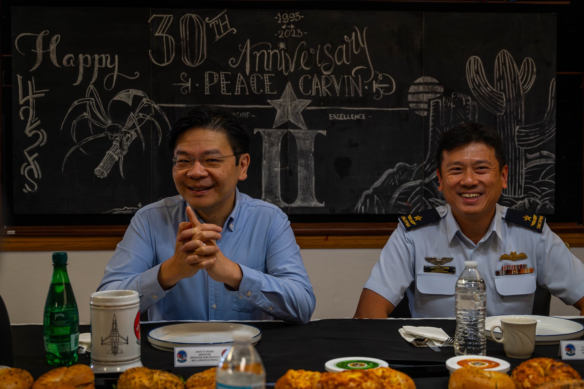 Lawrence Wong (left), Singapore Deputy Prime Minister and Minister of Finance, and Republic of Singapore Air Force Brig. Gen. Lim Kok Hong (right), RSAF Air Combat Command commander, attend a breakfast Oct. 6, 2023, at Luke Air Force Base, Arizona.