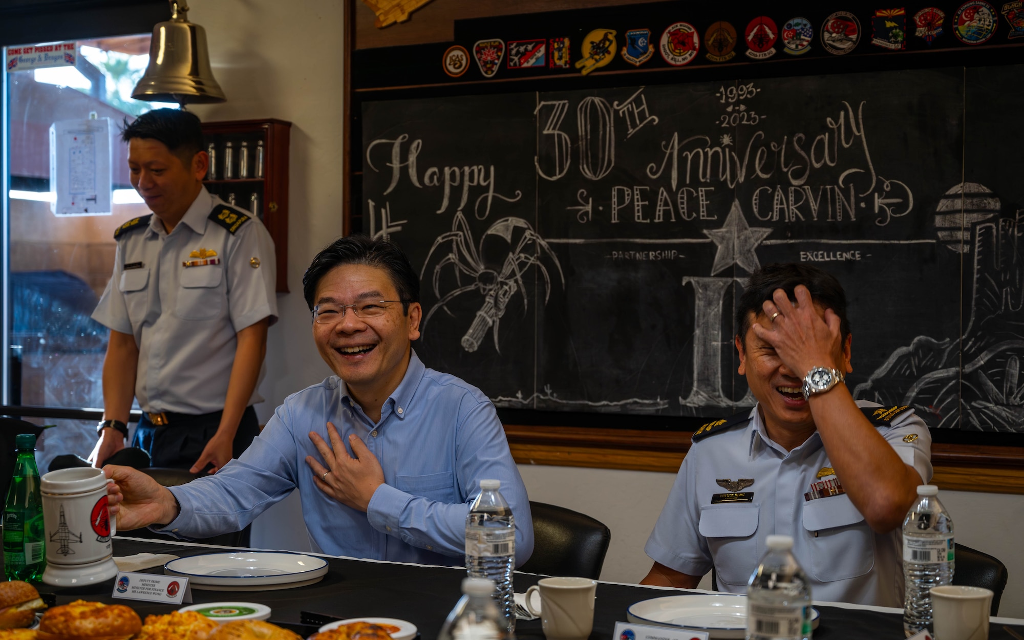 Lawrence Wong (left), Singapore Deputy Prime Minister and Minister of Finance, and Republic of Singapore Air Force Brig. Gen. Lim Kok Hong (right), RSAF Air Combat Command commander, attend a breakfast Oct. 6, 2023, at Luke Air Force Base, Arizona.