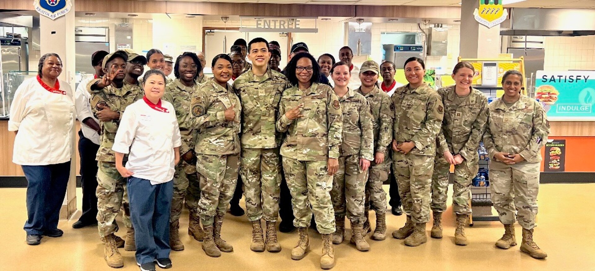 People stand together and smile for a group photo