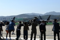 Visitors at the 2023 Seoul International Aerospace and Defense Exhibition take photos of U.S. Air Force aircraft during media day at Seoul Air Base, Republic of Korea, Oct. 16, 2023.