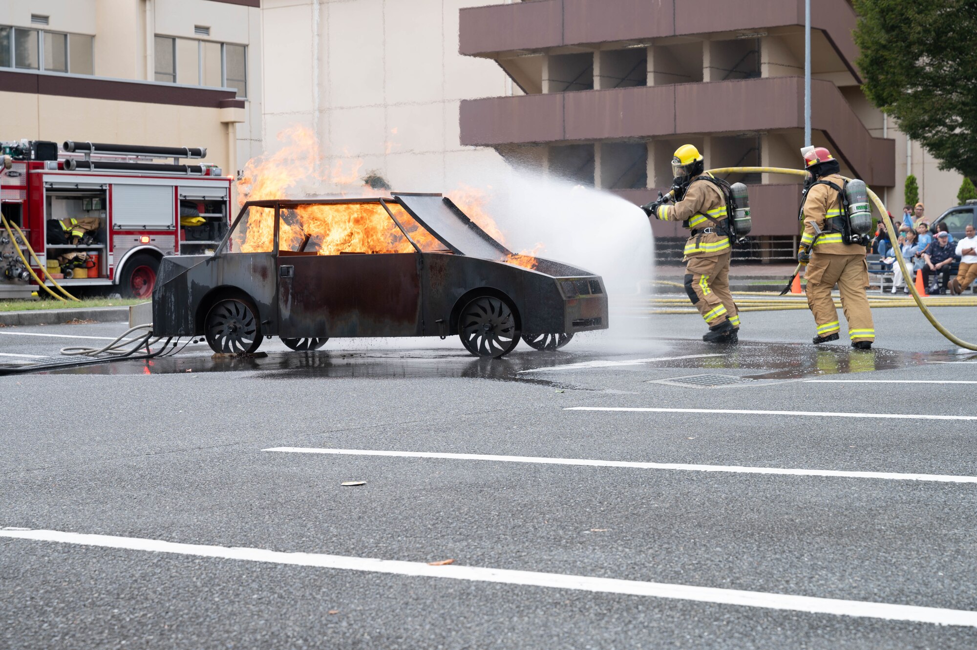 Firefighters perform a controlled fire demonstration.