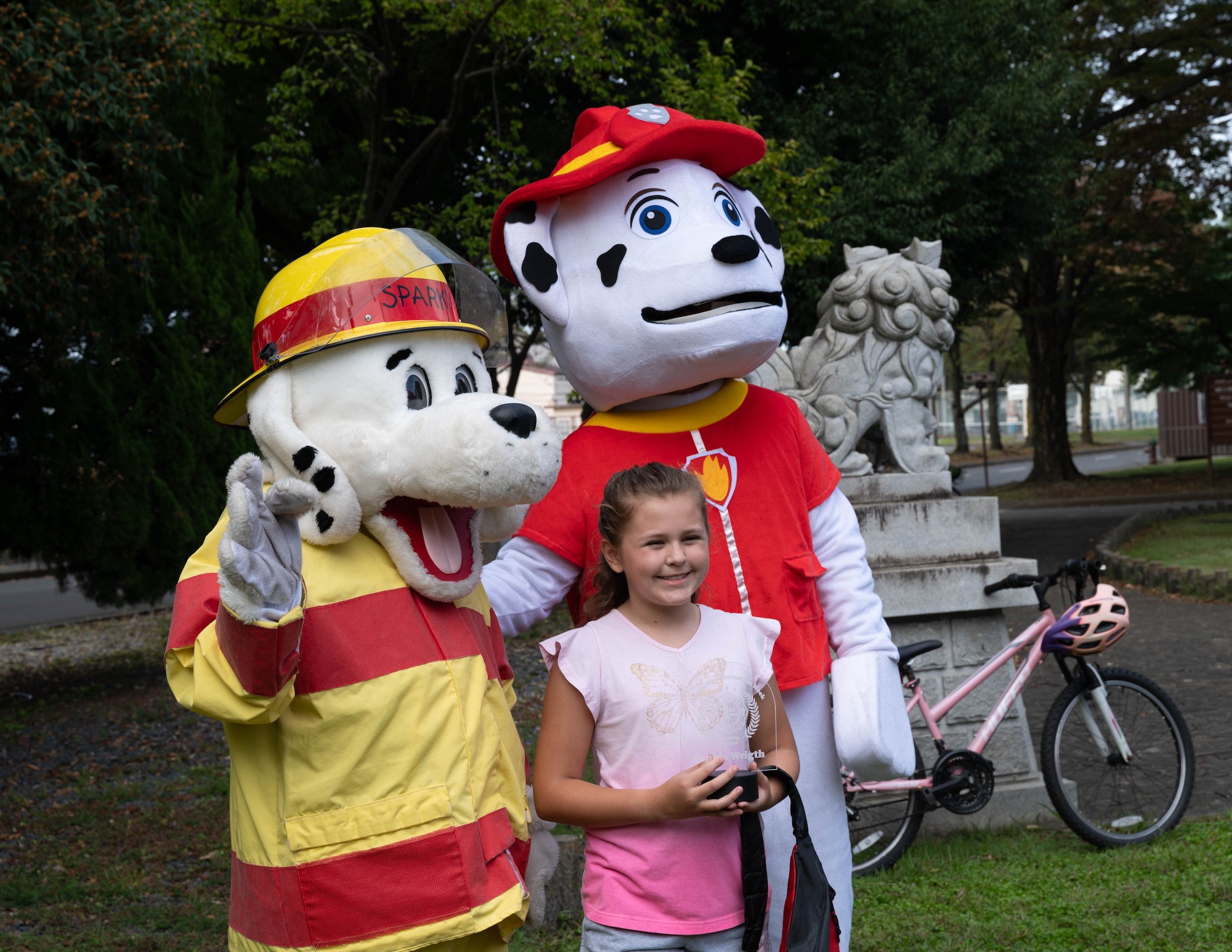 First responder mascots pose for a photo with an art contest winner.