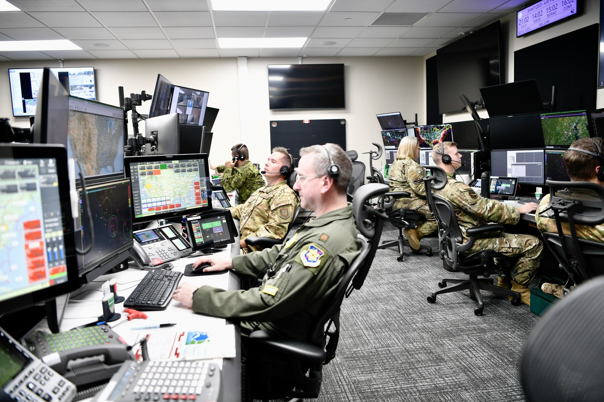 Airmen sitting at air defense computer stations